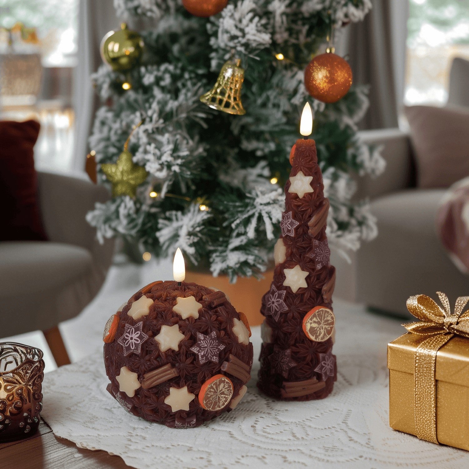Decorative candles with star and snowflake patterns on a table in front of a Christmas tree.#color_spice