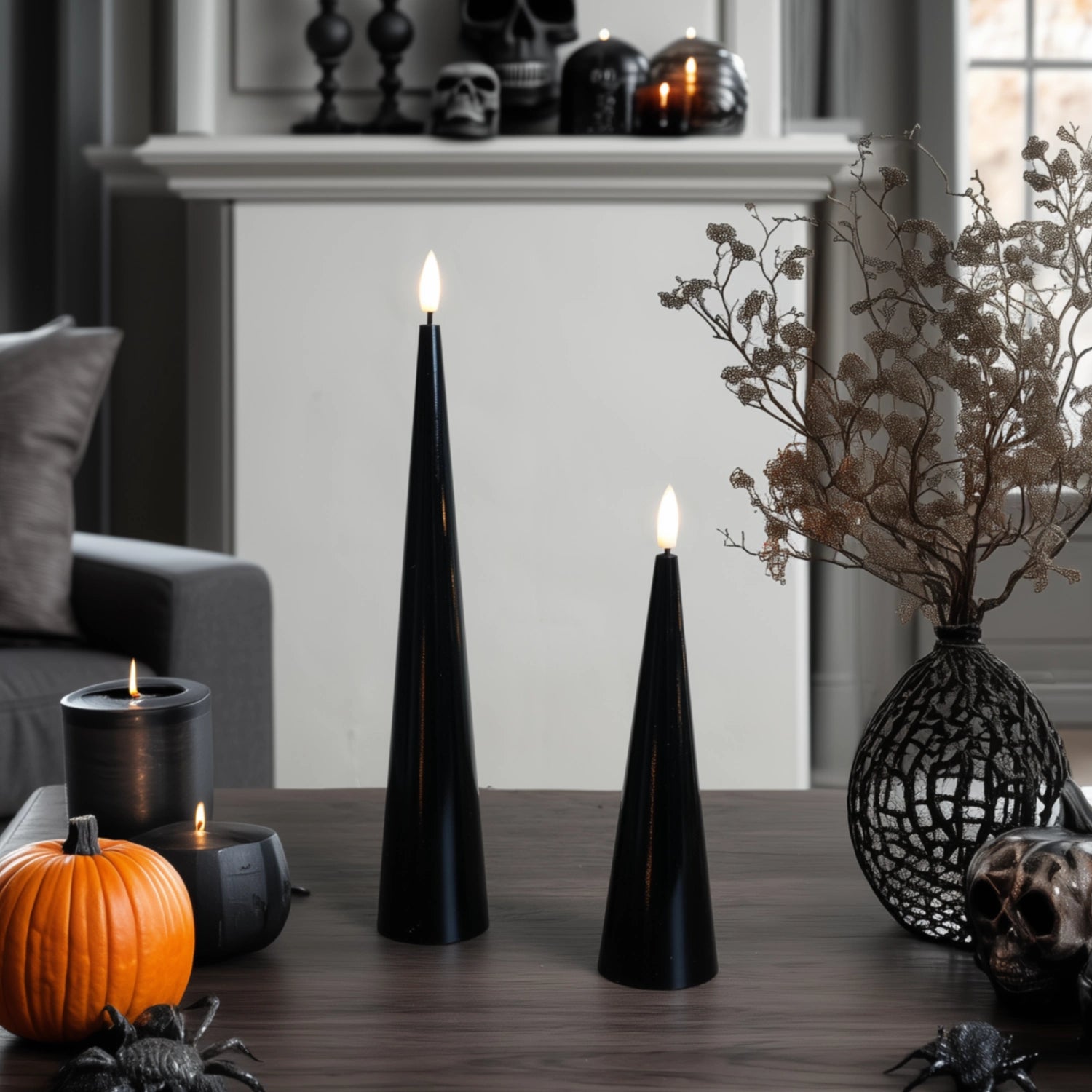 Black cone-shaped candles on a table with decorative elements in a room setting.#color_shiny-black