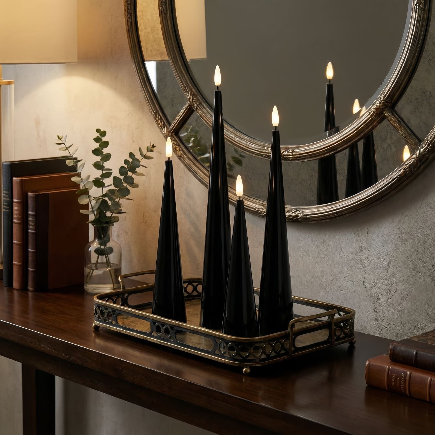 Black cone-shaped candles on a table with decorative elements.#color_shiny-black