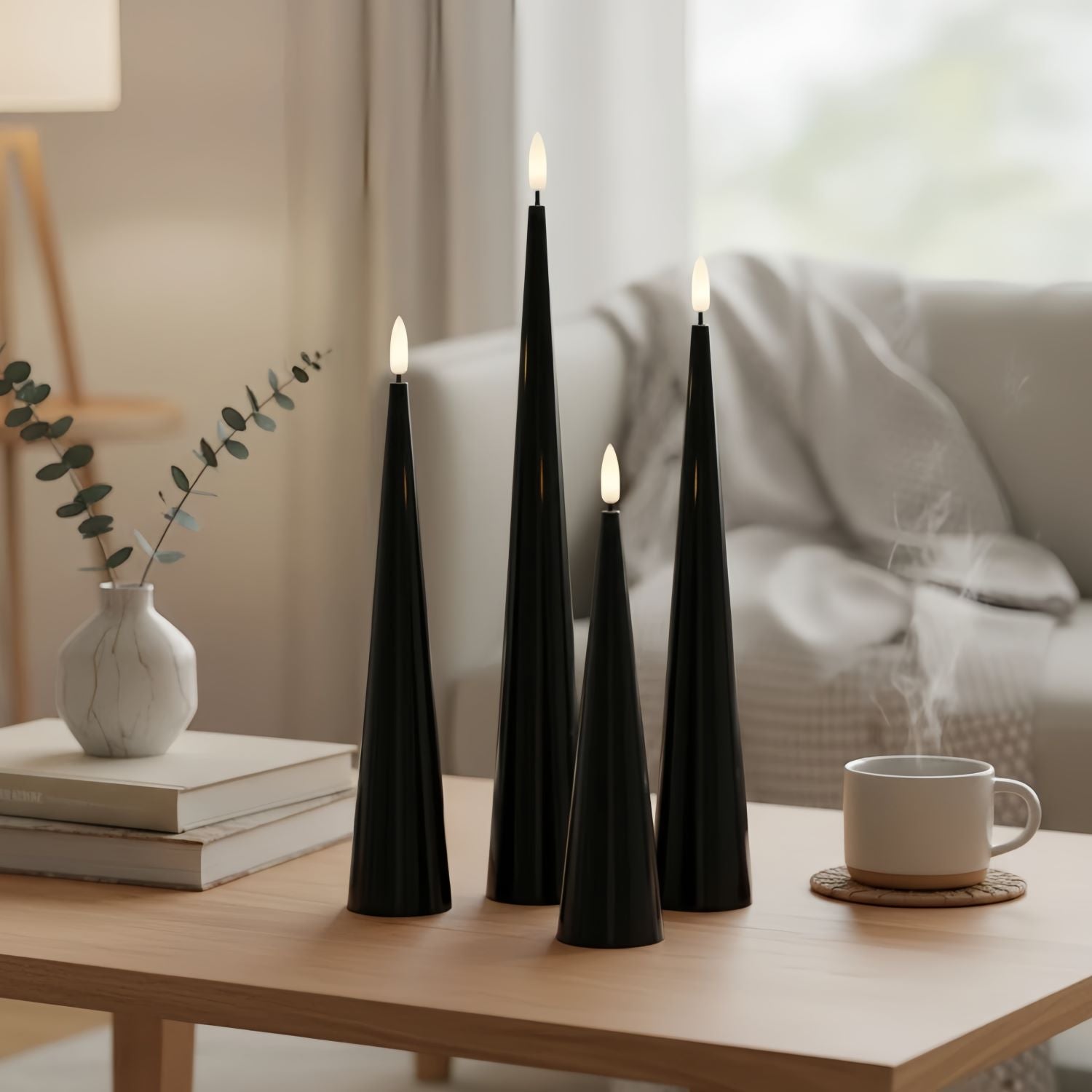 Black cone-shaped candles on a table with decorative elements.#color_shiny-black