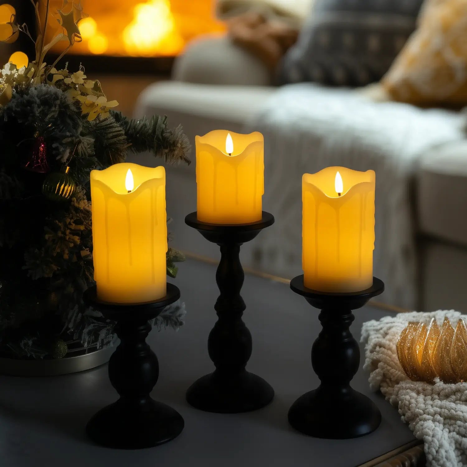 Decorative candles with greenery and berries on a table with blurred lights in the background#color_ivory