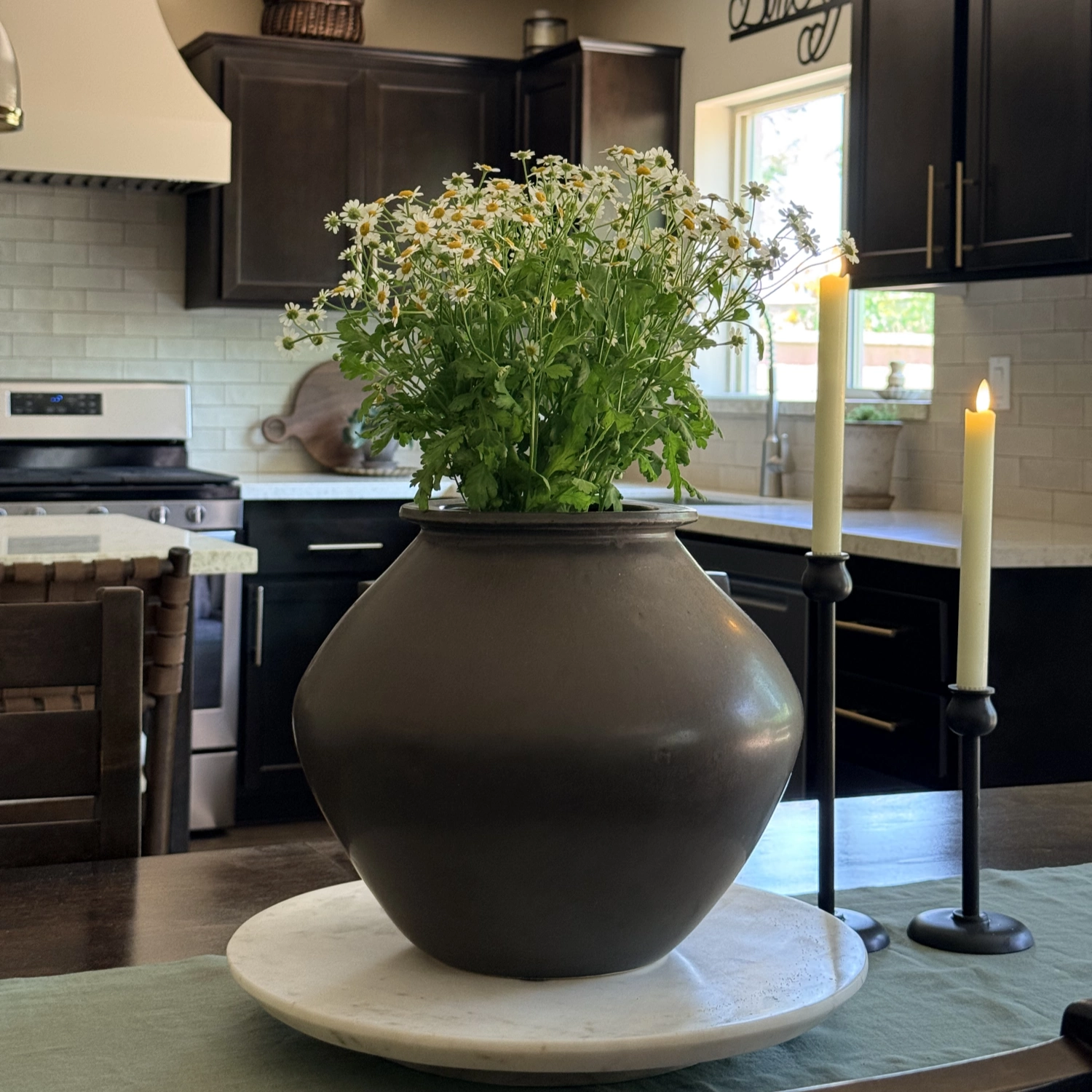 Decorative vase with flowers on a kitchen counter