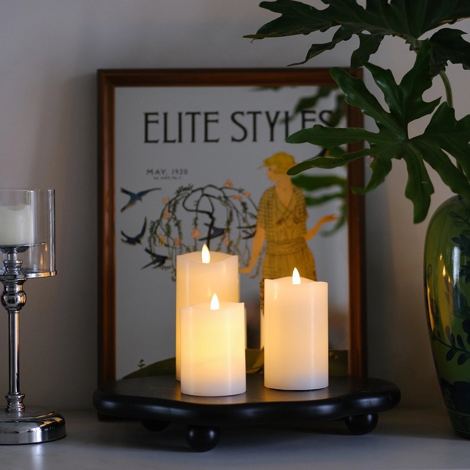 Decorative table setting with candles and greenery on a white tablecloth.#color_white