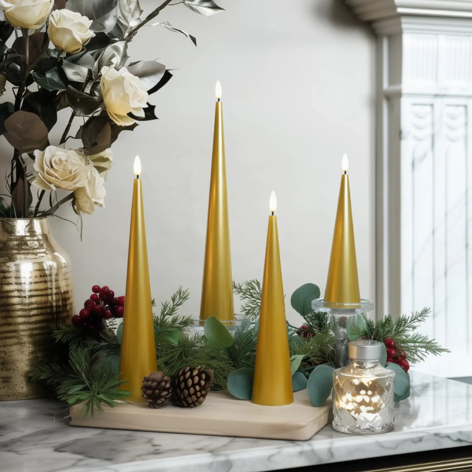 Decorative setup with gold candles, flowers, and greenery on a marble surface.#color_lacquered-gold