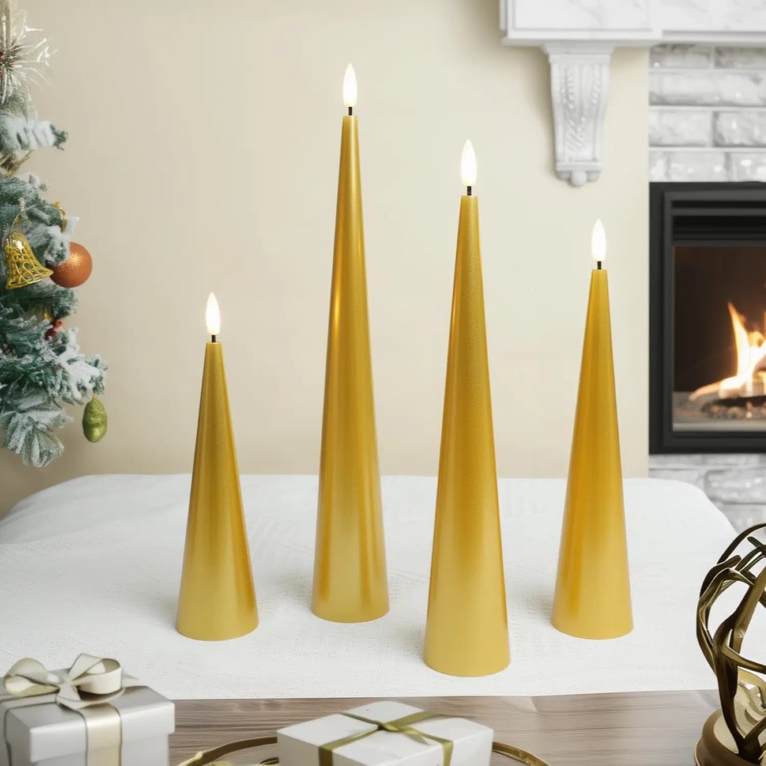 Gold taper candles on a table with a Christmas tree and fireplace in the background