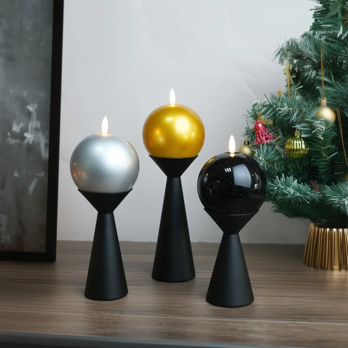 Gold candle on a wooden base with Christmas decorations in the background