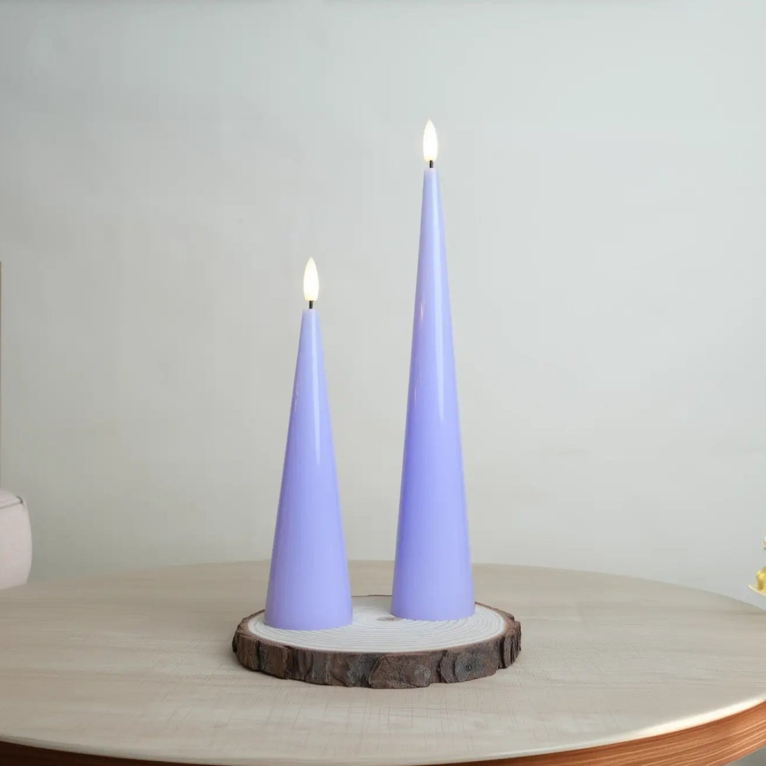 Two purple cone-shaped candles on a wooden base with a neutral background#color_shiny-purple