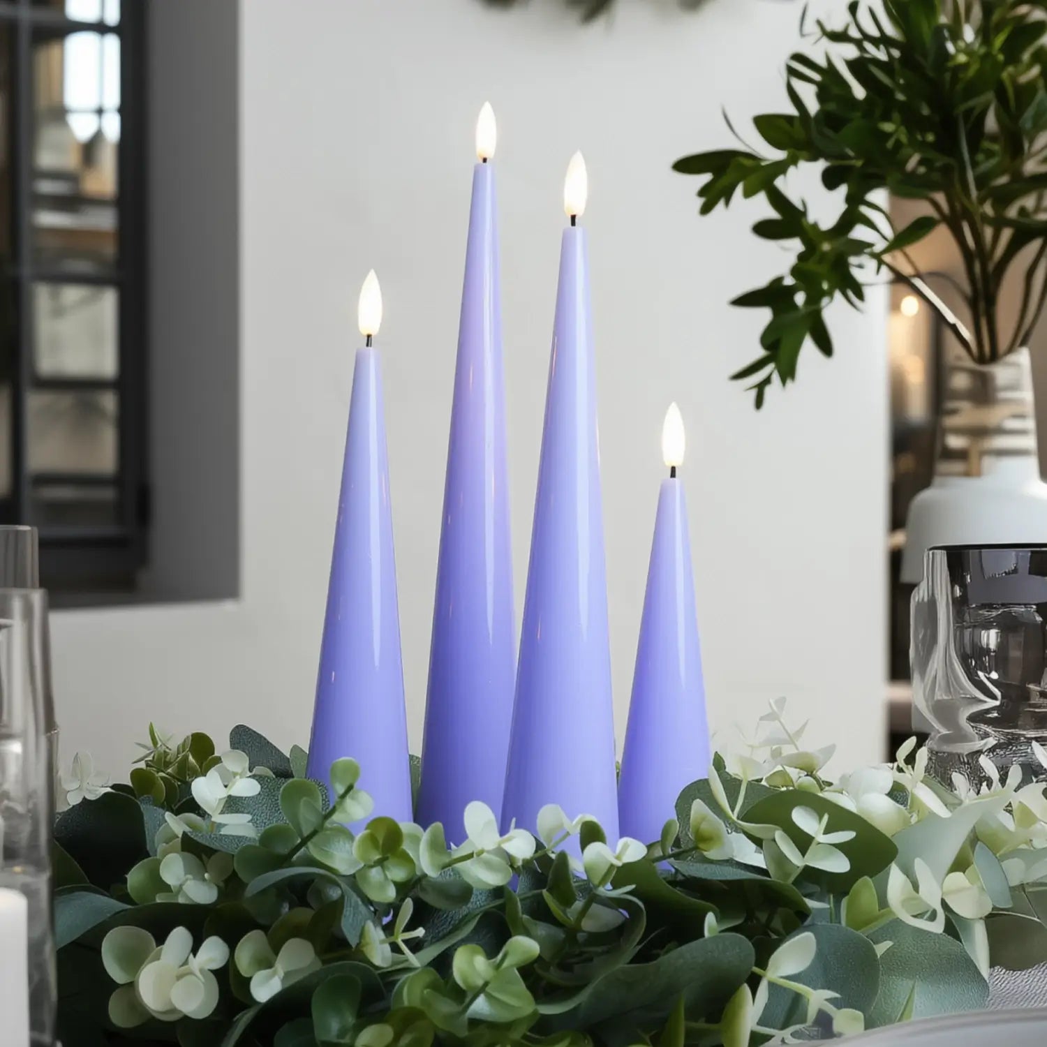 Purple candles on a decorative table with greenery#color_shiny-purple