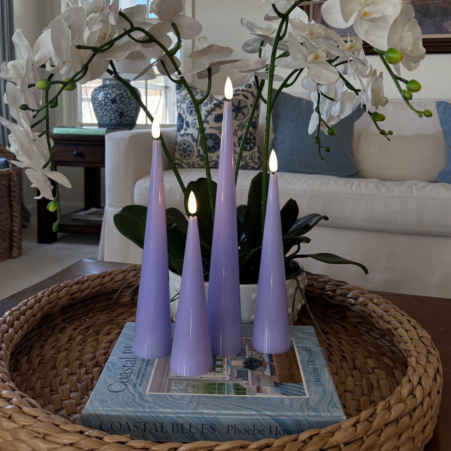 Purple candles on a decorative table with greenery#color_shiny-purple