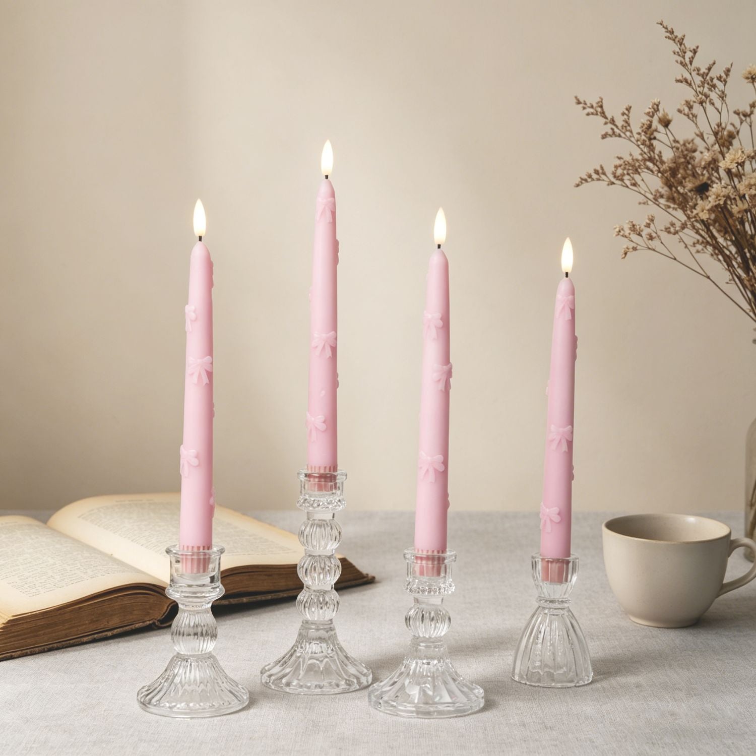 Easter table setting with pink and white tulips, candles, and floral tablecloth.