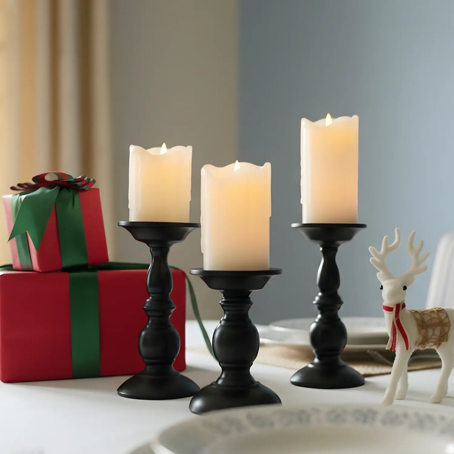 Two black candle holders on a wooden surface with a light gray background