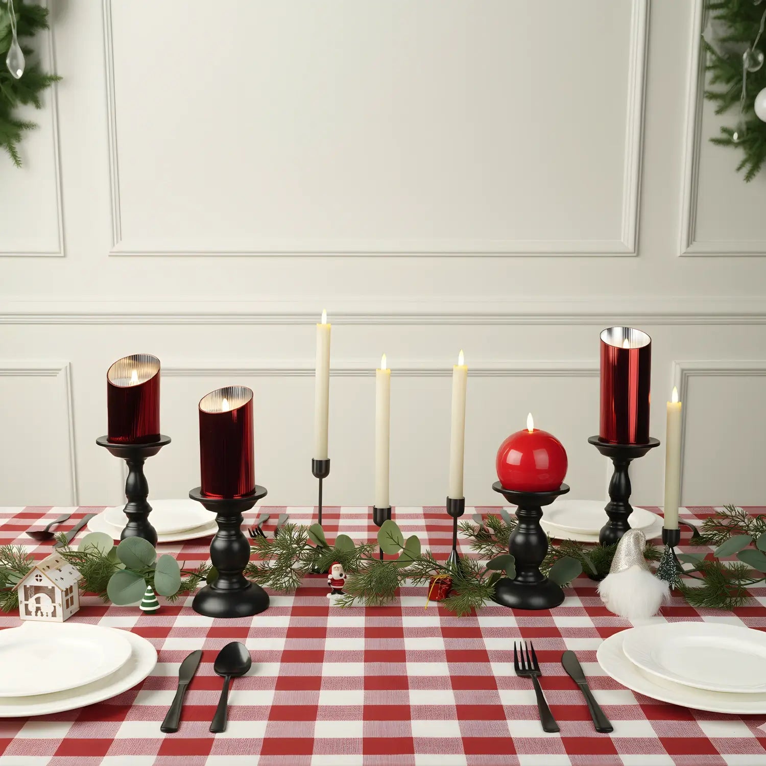 Two black candle holders on a wooden surface with a light gray background