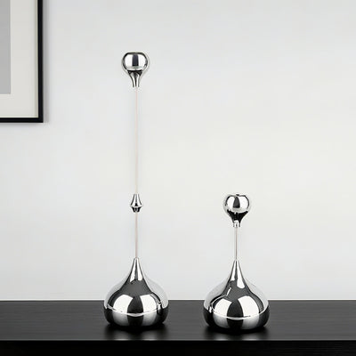 Two silver decorative vases on a dark surface with a light gray background