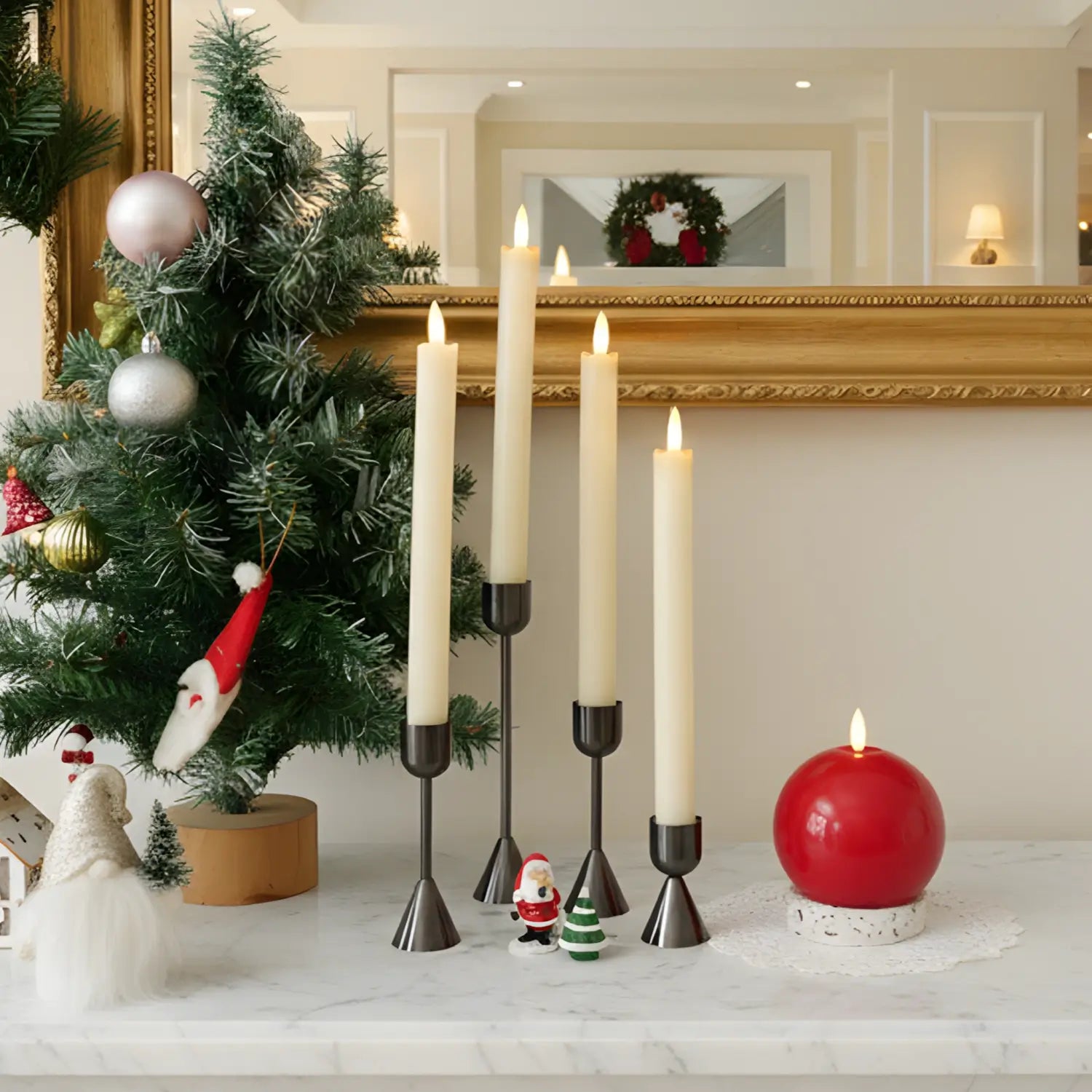 Set of black metal candle holders on a white surface with a blurred background