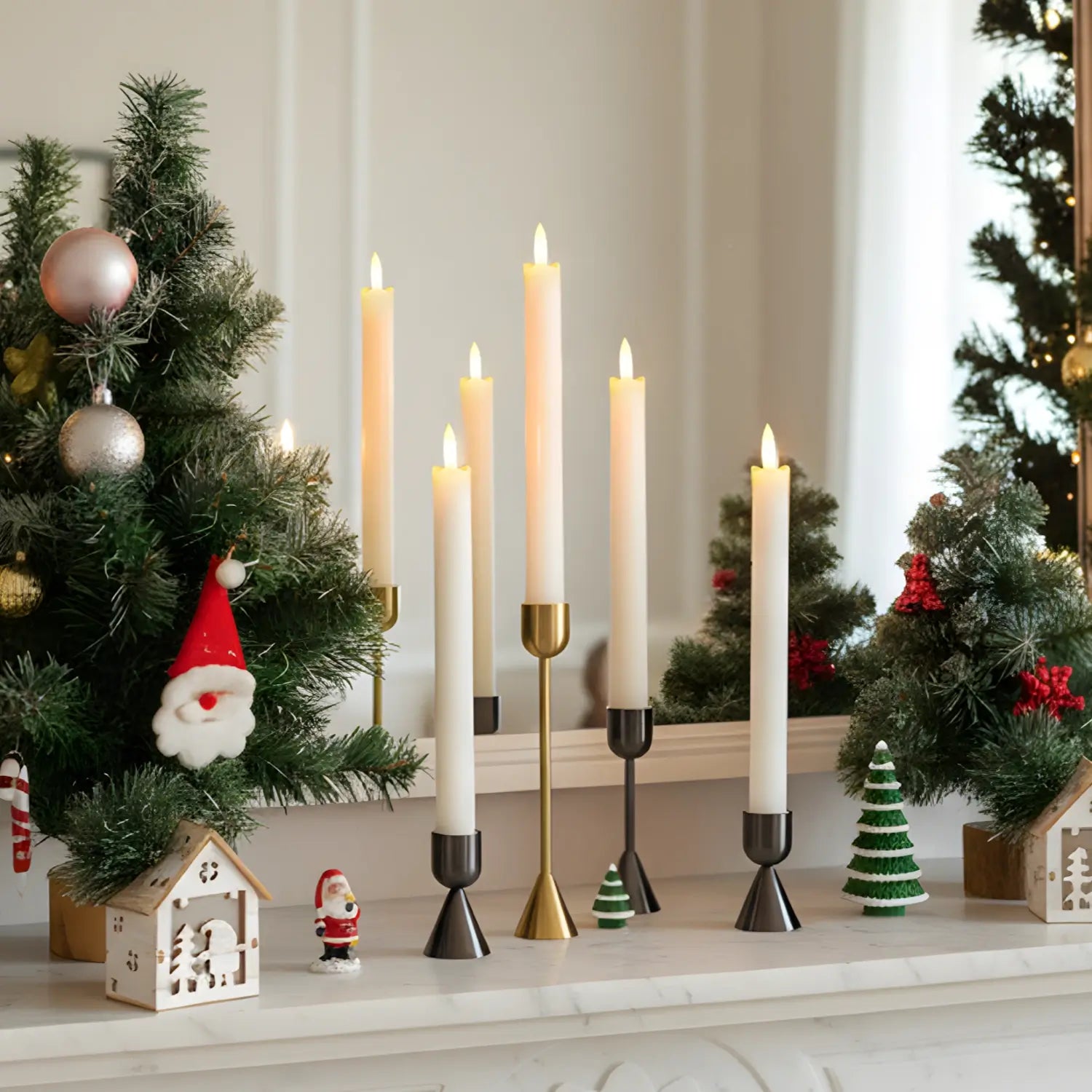 Set of black metal candle holders on a white surface with a blurred background