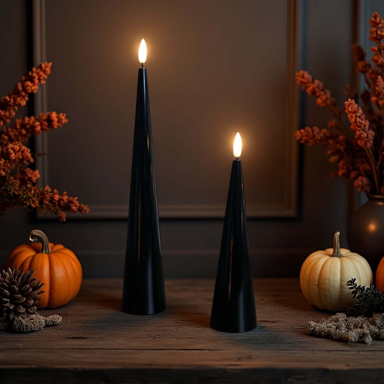Two black taper candles on a white tray with decorative elements in the background.#color_shiny-black