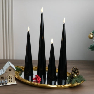 Black candles on a wooden base with a Christmas tree in the background