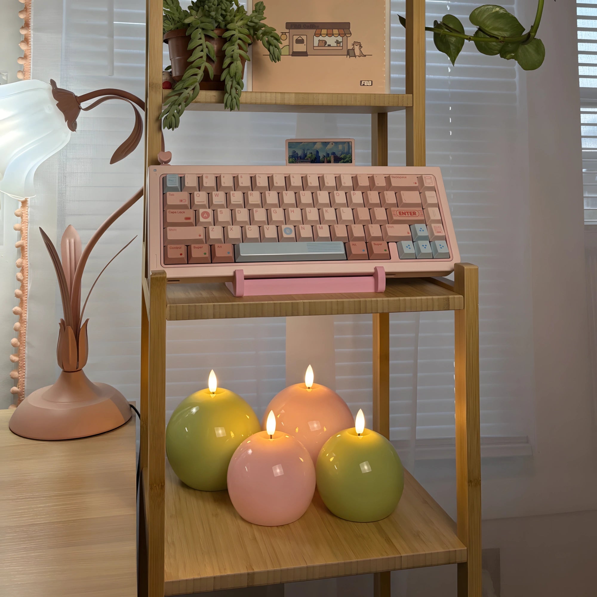 Wooden keyboard on a wooden shelf with lit candles and decorative plants.