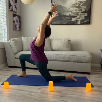 Person practicing yoga in a living room with a couch and decor.