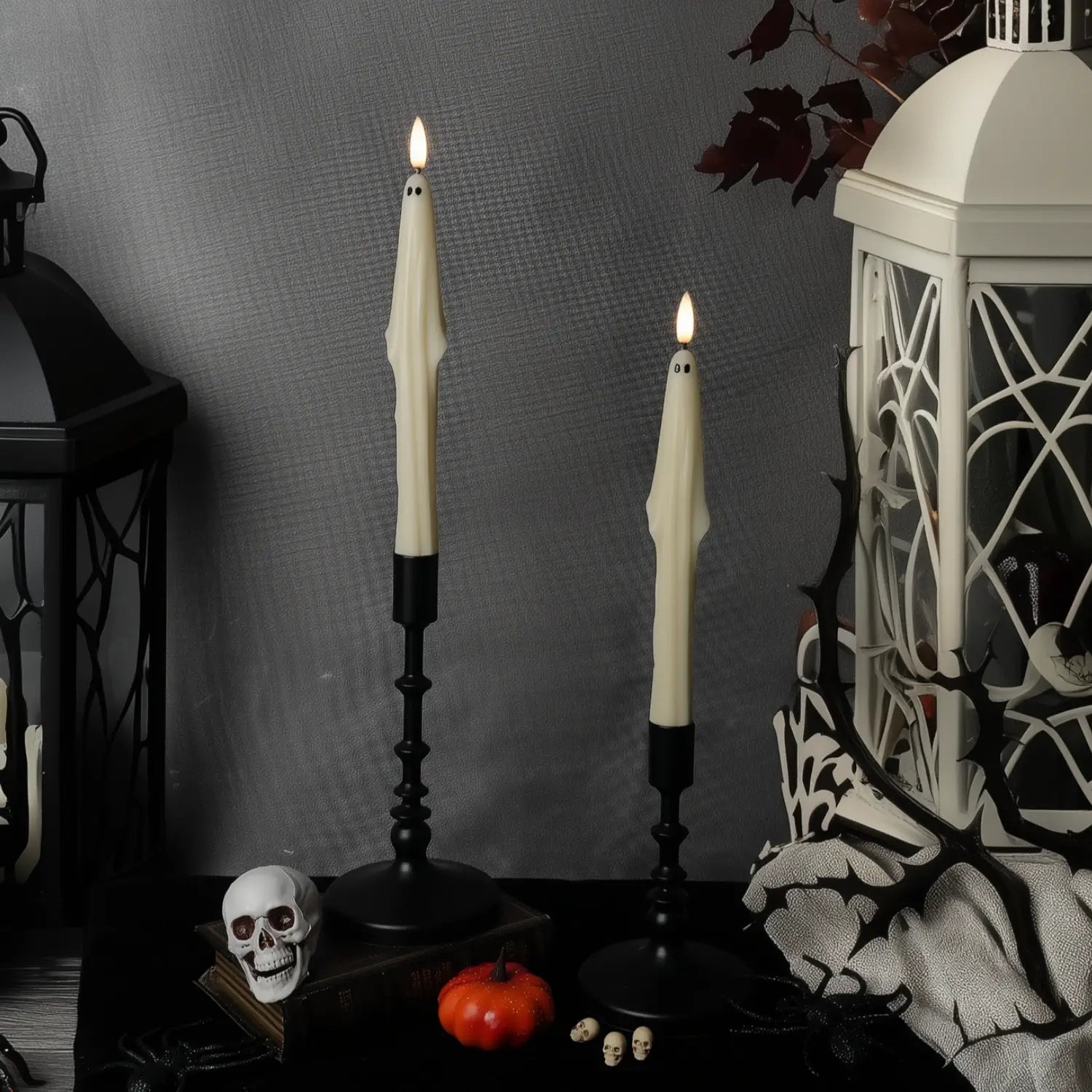 Halloween-themed decor with ghostly candles, lantern, and skeleton hand.