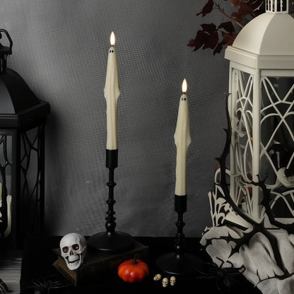 Halloween-themed decor with ghostly candles, lantern, and skeleton hand.
