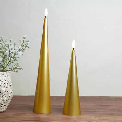 Two gold cone-shaped candles on a wooden surface with a neutral background