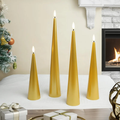Gold taper candles on a table with a Christmas tree and fireplace in the background