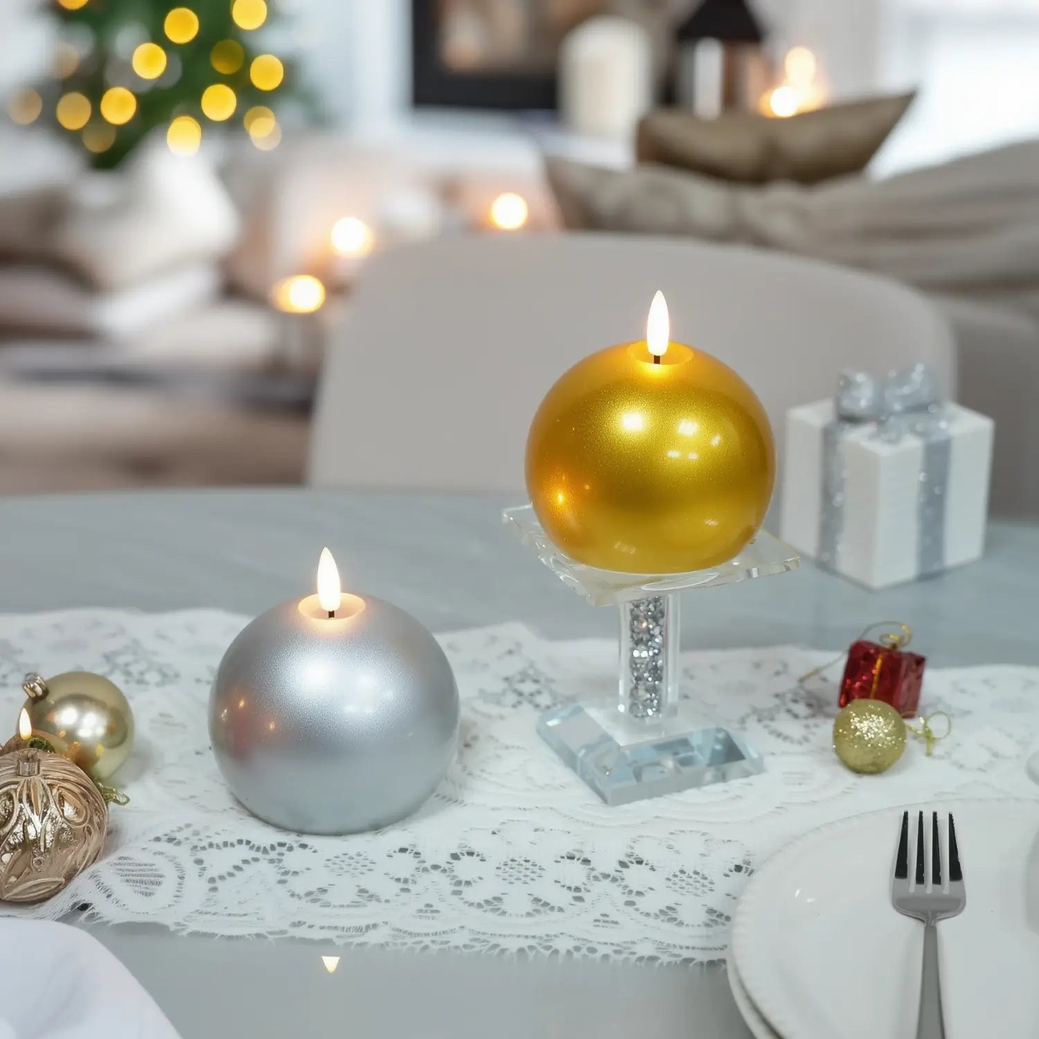 Gold candle on a wooden base with Christmas decorations in the background