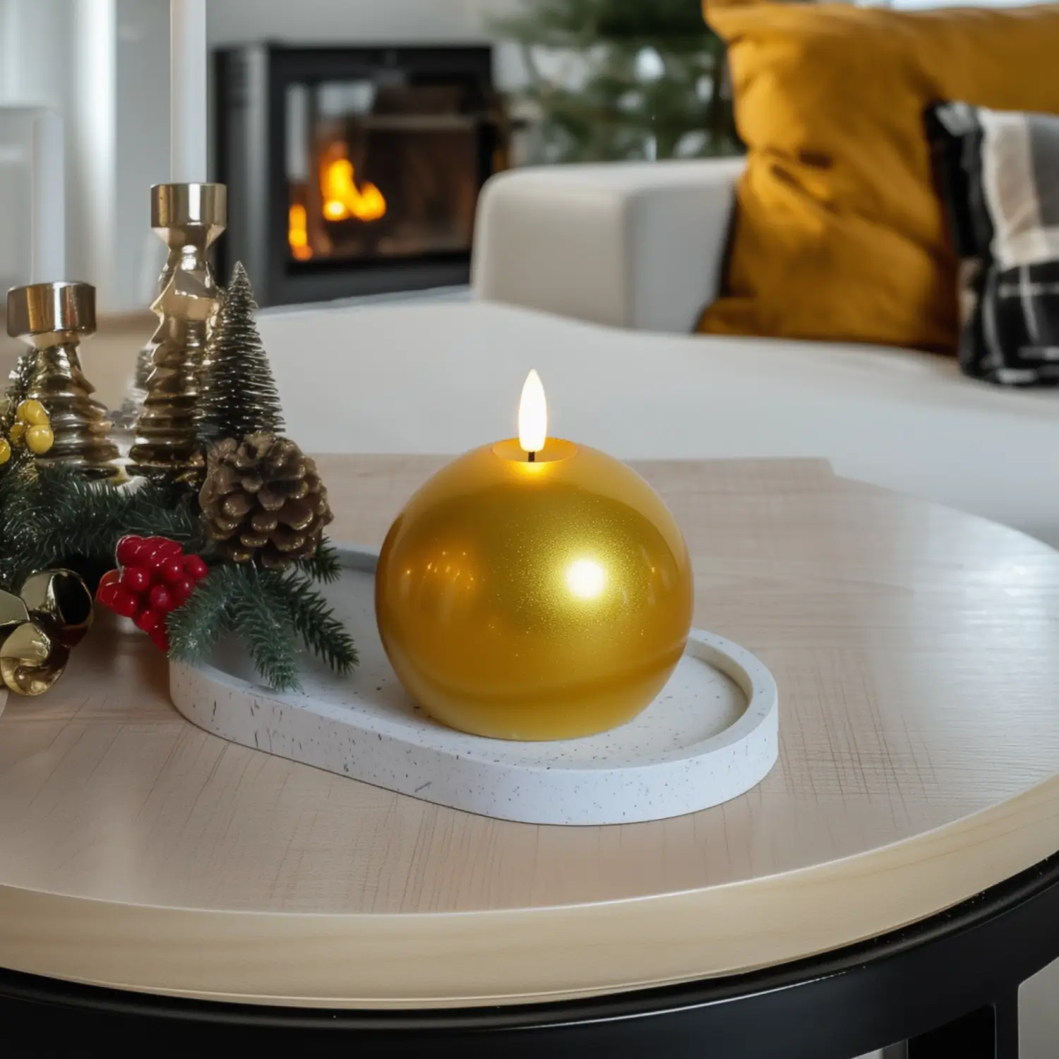 Decorative setup with a gold candle on a table in a cozy living room.