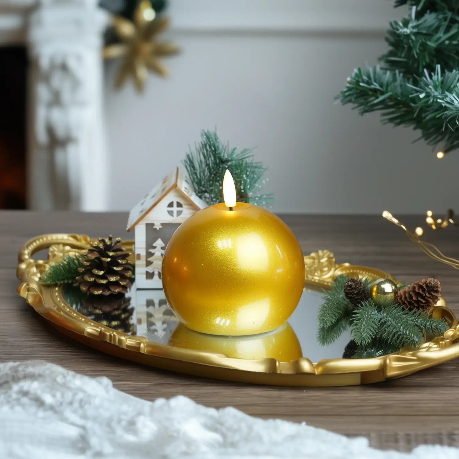 Gold candle on a wooden base with Christmas decorations in the background