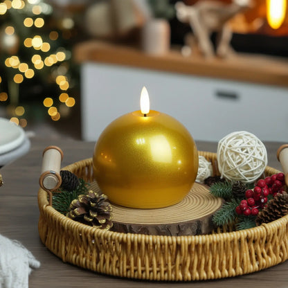 Gold candle on a wooden base with Christmas decorations in the background