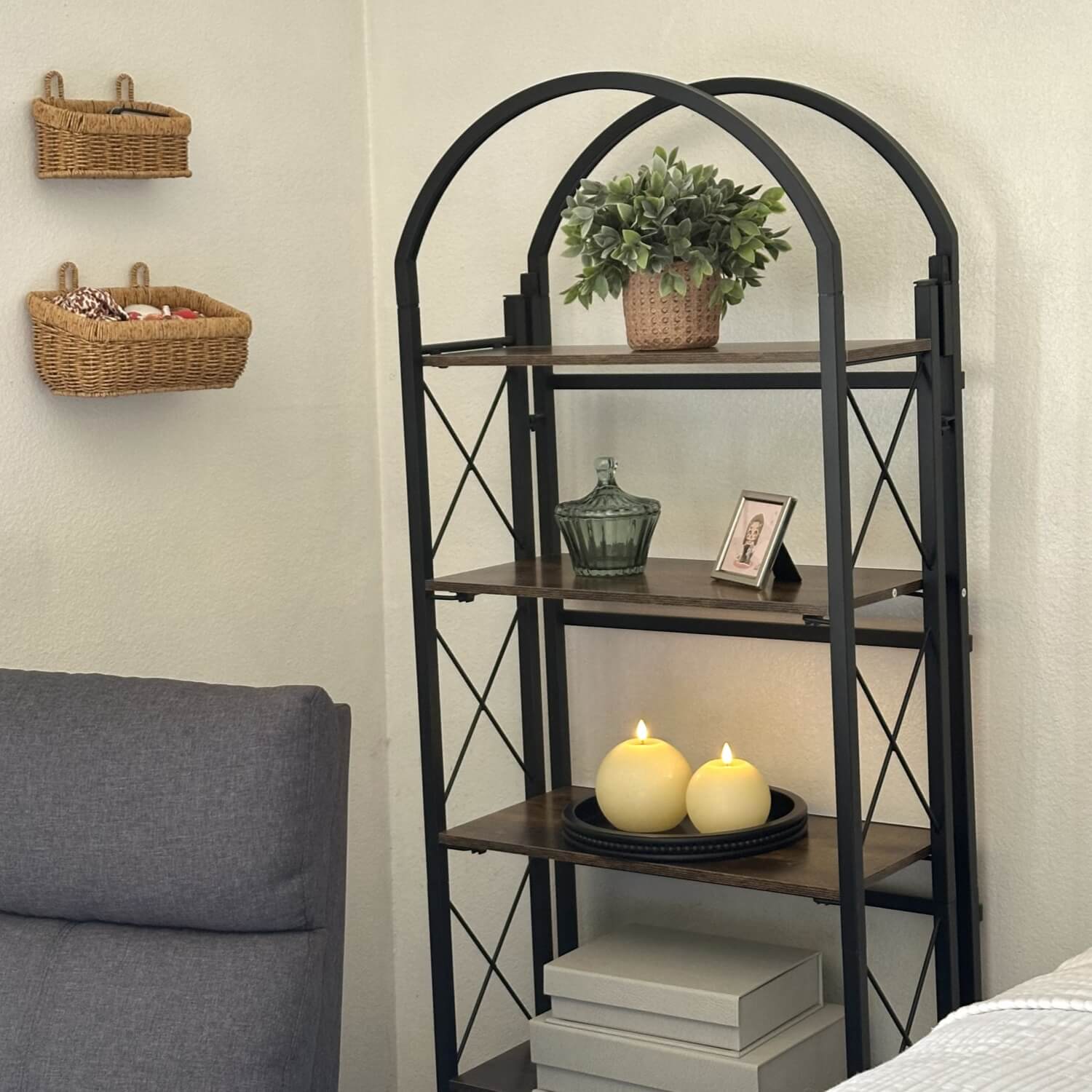 Black metal shelf with decorative items in a room setting