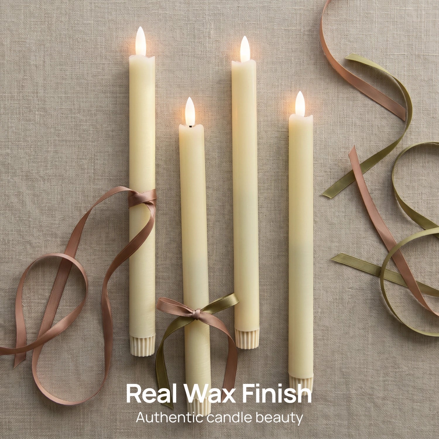 Four cream-colored taper candles with lit flame tops, tied with brown and olive ribbons, arranged on a textured beige fabric background with decorative ribbon loops. Text at the bottom reads 'Real Wax Finish' and 'Authentic candle beauty'.