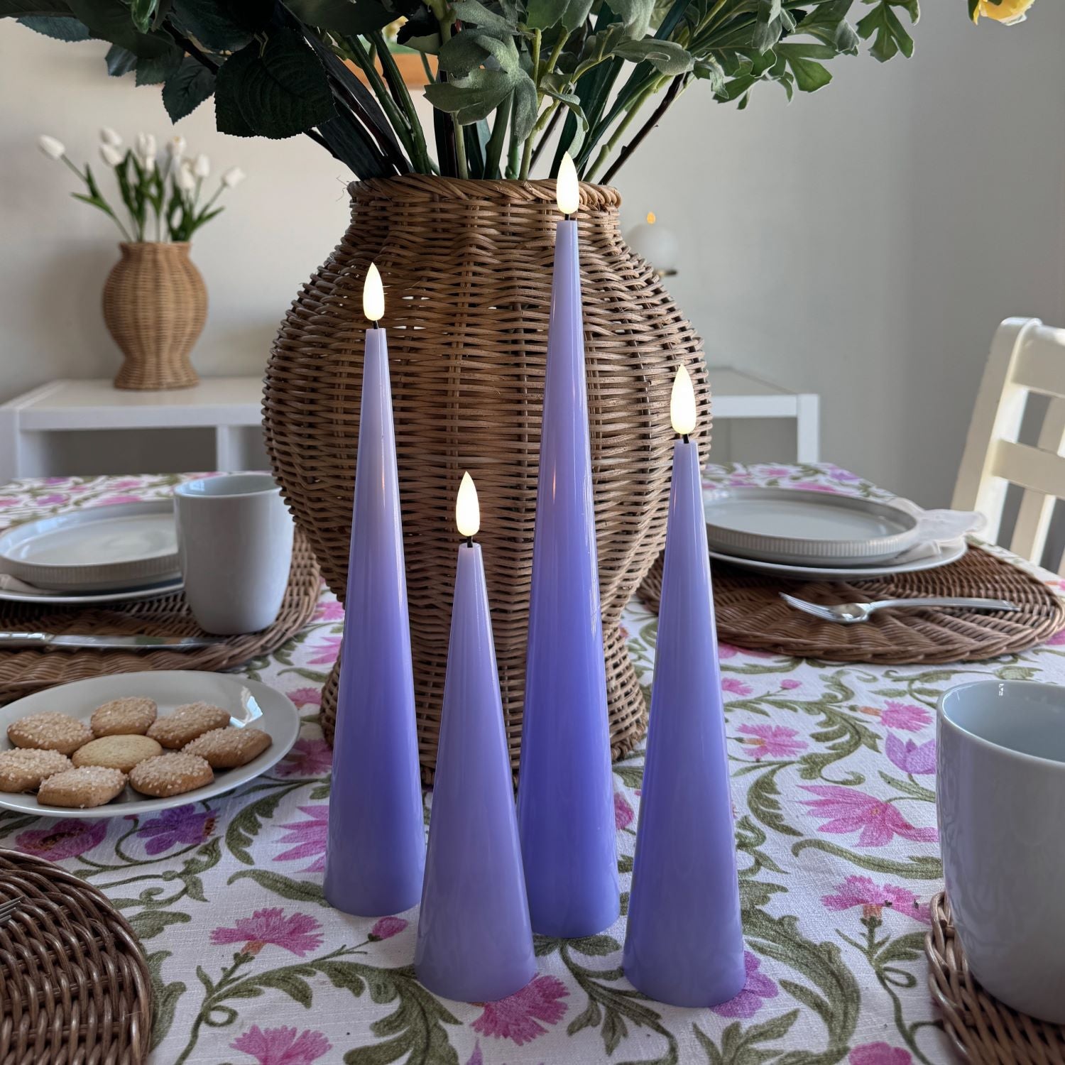 Purple candles on a decorative table with greenery#color_shiny-purple