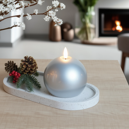 Decorative candle on a stone tray with festive elements in a cozy living room.