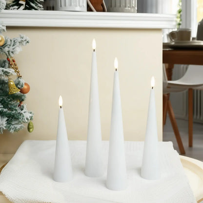 White cone-shaped candles on a table with a Christmas tree in the background