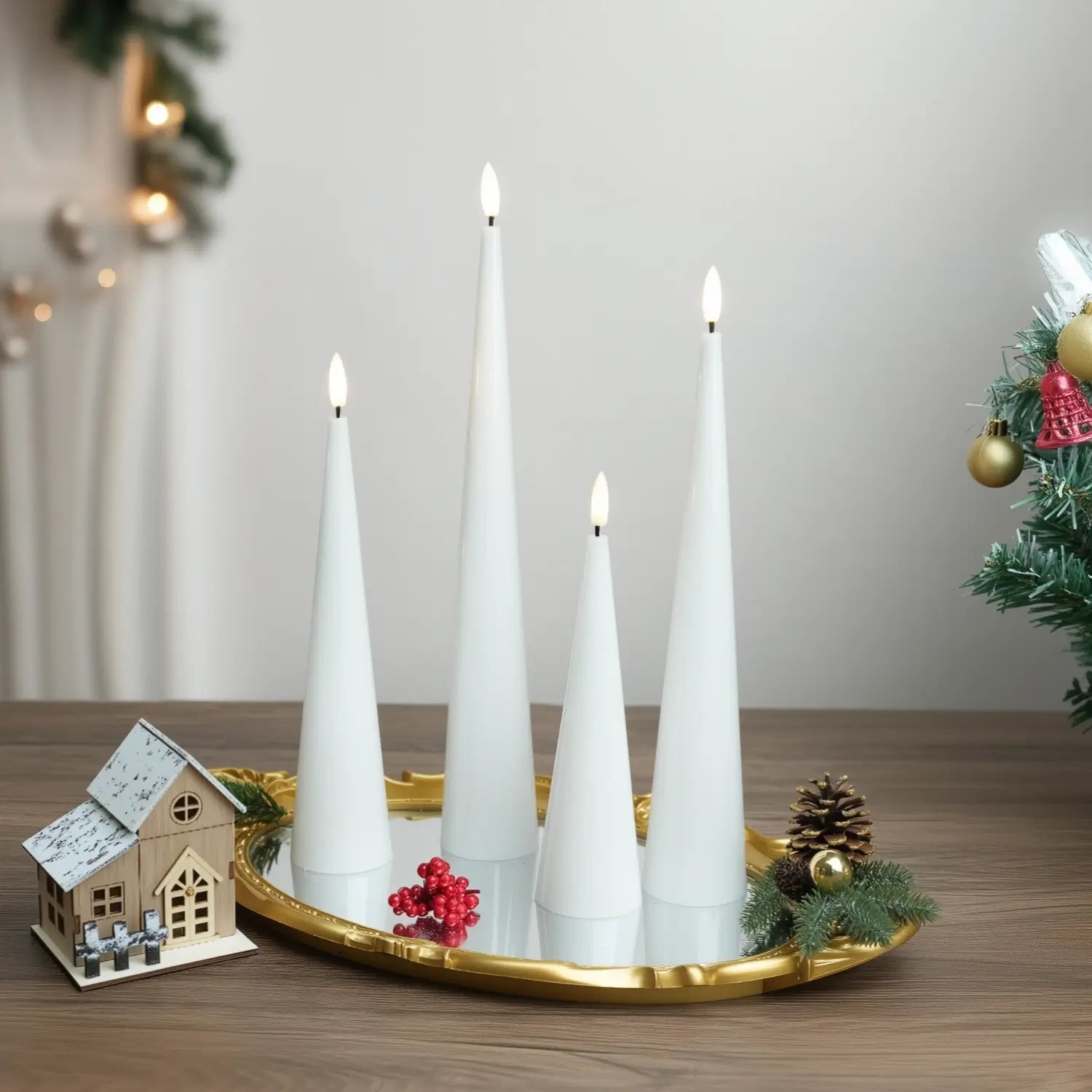 Decorative setup with white candles, pumpkins, and a skull on a neutral background