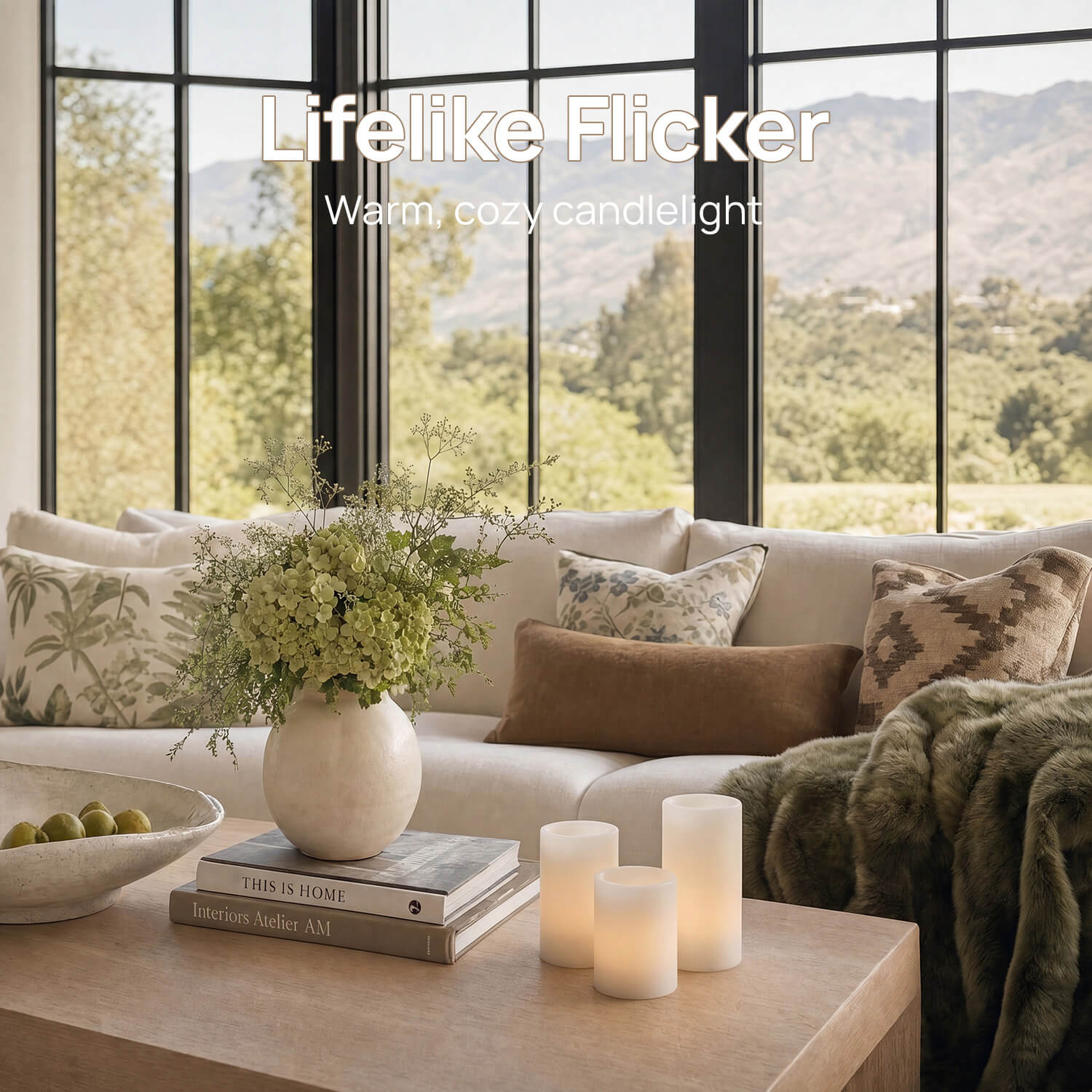 Cozy living room with candles, flowers, and a view of mountains