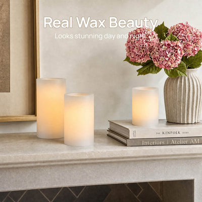 Decorative setup with candles and flowers on a surface, featuring 'Real Wax Beauty' text.